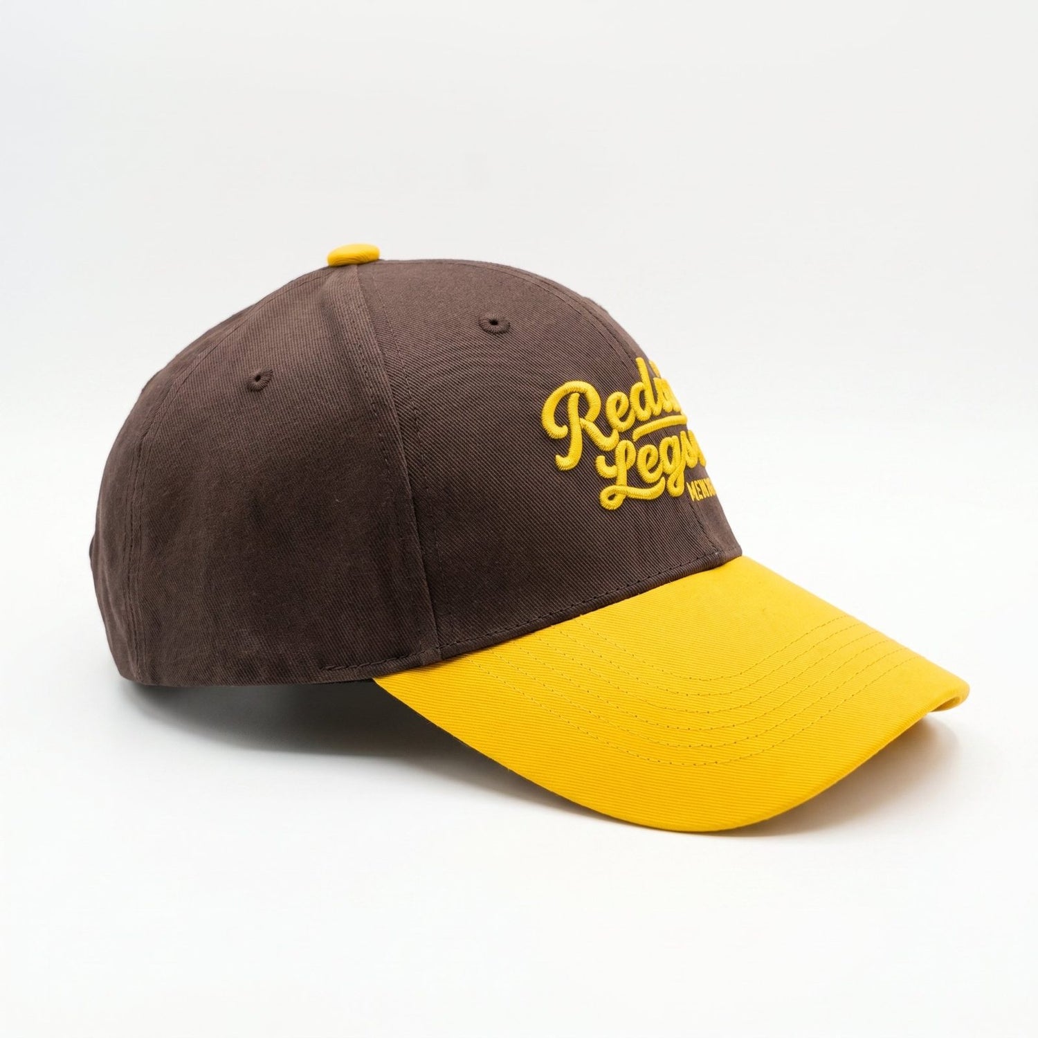 Brown &amp; Gold Snapback Cap by Redneck Legends — side view of the structured brown crown and golden-yellow curved bill.