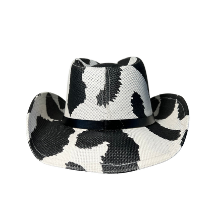 Black Cow Print Cowboy Hat by Redneck Legends — black-and-white cow-print spots on white basketweave straw with a tonal black band